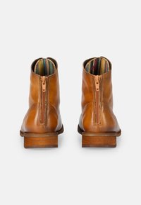 Brown leather ankle boots with a zipper closure, featuring a striped inner lining and a wooden heel. Smooth texture and rounded toe design.