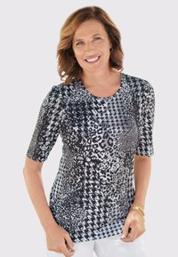 Kurzärmliges Oberteil mit einem schwarz-weißen Mischmuster aus Leopardenflecken und Hahnentritt, mit Rundhalsausschnitt und dehnbarem Stoff.