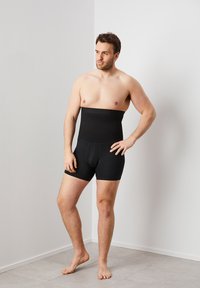 Black body-shaping shorts with a high waistband and a smooth, stretchy texture. Designed to provide support and a streamlined appearance.