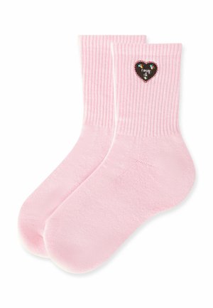 Light pink ribbed socks with a small black heart patch decorated with colorful flowers and text on the outer side near the cuff.