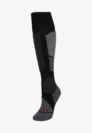 Knee-high socks made from a blend of textured black and grey materials, featuring a geometric pattern and reinforced toe, with red branding.