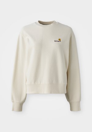 Lys beige sweatshirt med rund halsudskæring, ribbede manchetter og kant. Har et lille brunt broderet logo på venstre bryst.