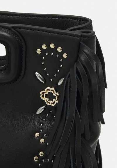 Black leather handbag featuring metallic studs, fringe details, a floral accent, and smooth texture. Close-up view focusing on design elements.