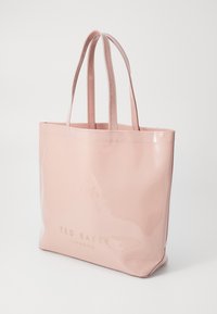 Rosa, glansig tygväska med stadiga handtag och präglad "TED BAKER LONDON"-logotyp på framsidan. Slät textur och rektangulär form.