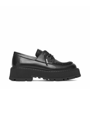 Black leather loafer with thick ridged platform sole, lace detail on top, and stitched moccasin-style front.
