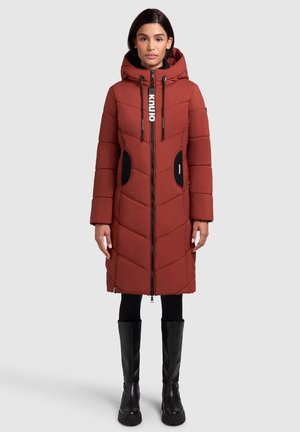 Padded red coat with a hood, featuring diagonal quilted design, black pockets, and a full-length zipper. Black tall boots complete the look.