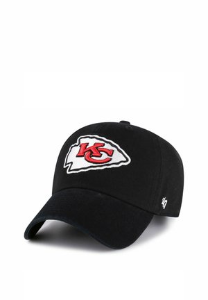 Black baseball cap with red "KC" logo inside white arrowhead, white "47" logo on the side, angled front view on white background.