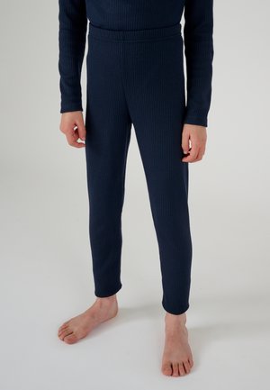 Leggings de canalé en color azul marino con un diseño ajustado y una cintura alta, confeccionados en una suave tela que se extiende hasta los tobillos con una textura lisa.