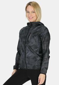 Black, lightweight jacket with a hood; shiny, textured fabric; front zipper closure; elastic cuffs; features logo detail.