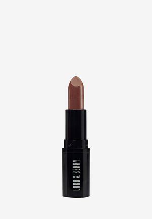 Lipstick in een kogelvorm met een puntige tip. De tube is zwart met witte tekst; de lipkleur is een zachte, gematteerde nude-bruin.
