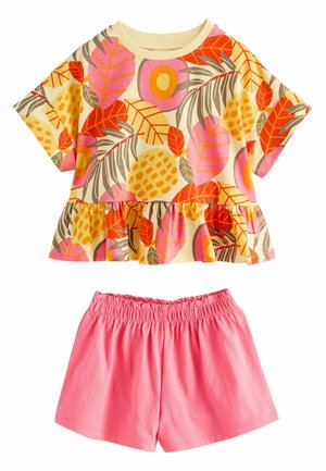 Short-sleeve toddler top with colorful tropical leaf print, ruffled hem, paired with elastic waist bright pink shorts.
