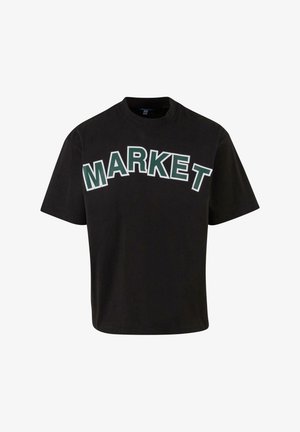 Black short-sleeve t-shirt featuring bold white and green "MARKET" text across the front. Made of soft cotton material. Round neckline.