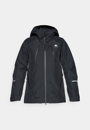 Svart vattentät jacka med huva, två dragkedjeförsedda bröstfickor, justerbara ärmslut och en diskret logotyp på vänster bröst. GORE-TEX-material.