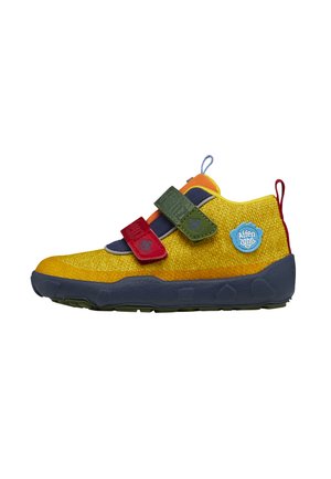 Yellow shoe with a textured surface, featuring Velcro straps in red and green, a blue accent, and a rugged sole for traction.
