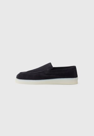 Navy suede slip-on shoe with a smooth finish, rounded toe, and a low white rubber sole. Minimalistic design, no visible hardware or patterns.