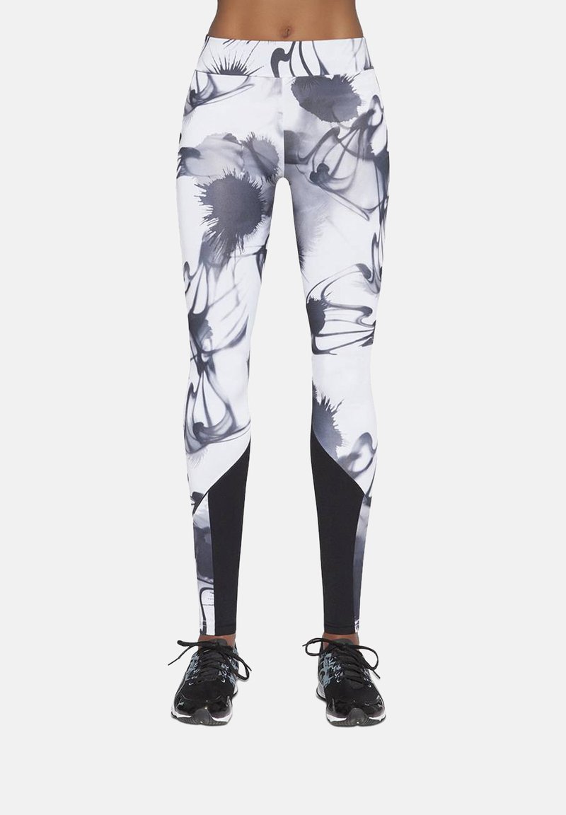 Legginsy z wysokim stanem, ozdobione czarno-białym kwiatowym wzorem, wykonane z gładkiej tkaniny, z czarnymi wstawkami po bokach na dole dla uzyskania smukłego wyglądu.