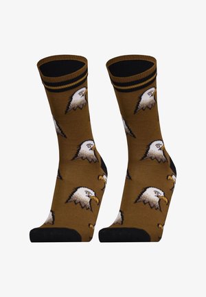 Brown socks featuring multiple eagle head designs, black cuffs and soles, with a soft texture and a fitted shape.