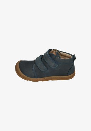 Navy leather shoe with double Velcro straps, beige lining, and a flexible brown rubber sole. Rounded toe and stitched detailing.