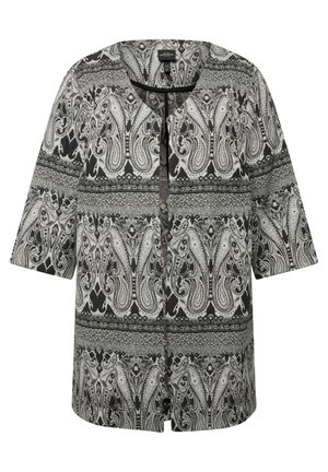 Mustavalkoinen kuvioitu takki, jossa on lyhyet hihat, V-pääntie ja koristeellisia paisleymotiiveja. Takissa on rento malli ja hienovarainen rakenne.