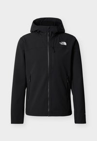 Veste d'extérieur noire à capuche avec fermeture éclair frontale, deux poches latérales zippées, une poche poitrine zippée et logo blanc "The North Face" sur la poitrine.