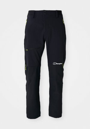 Pantaloni de exterior negri cu accente verzi, prevăzuți cu multiple buzunare cu fermoar, dintr-un material durabil și cu un design aerodinamic pentru funcționalitate.