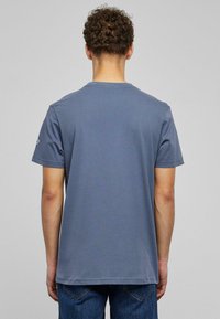 Gray short-sleeve t-shirt made of cotton, featuring a round neckline and simple design with no prominent patterns or accents.