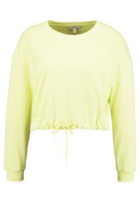 Felpa cropped a maniche lunghe di colore giallo chiaro, realizzata in tessuto testurizzato. Presenta un laccio in vita e un collo rotondo.