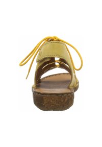 Yellow leather sandal with open sides, rear tie, and textured brown sole. Features a smooth upper and cushioned insole for comfort.
