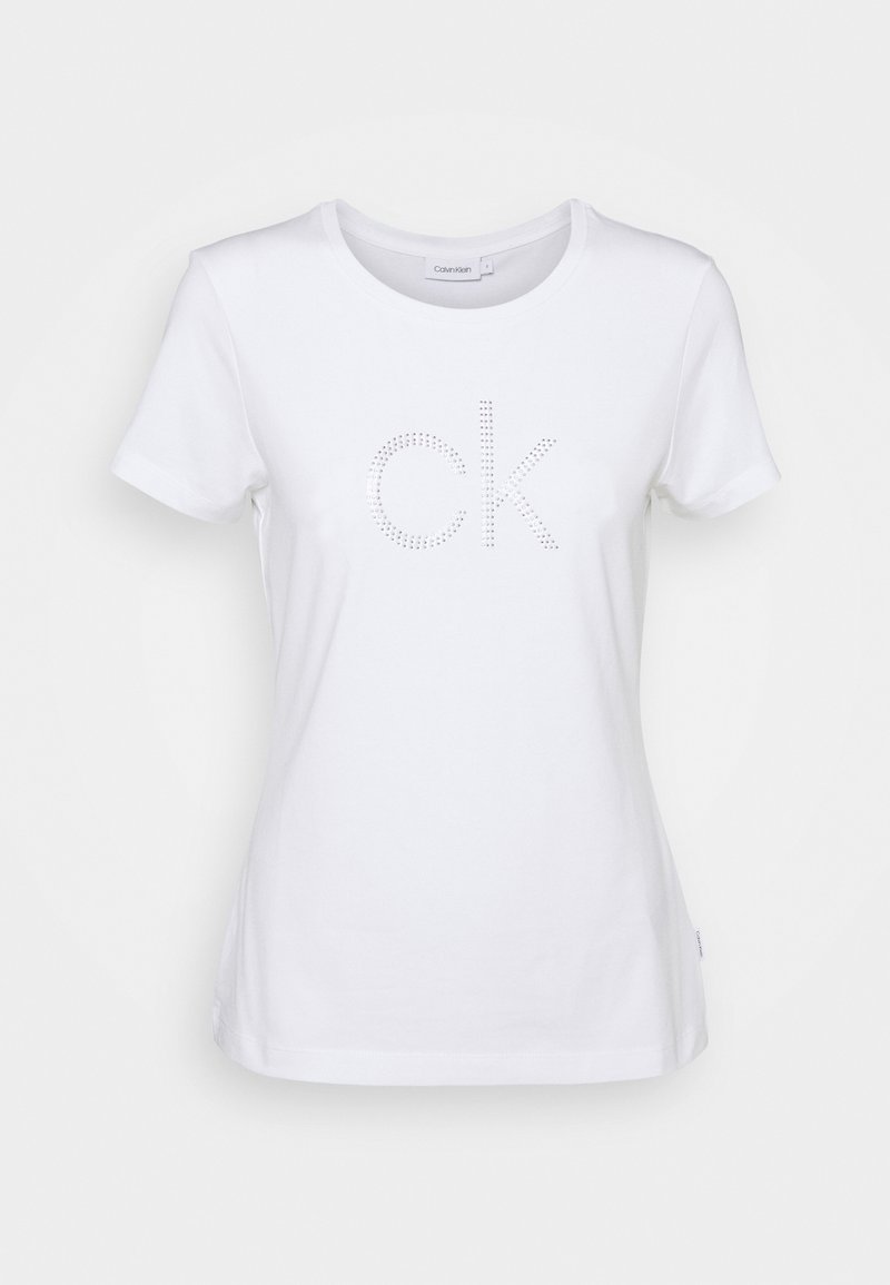 Valkoinen lyhythihainen T-paita, joka on valmistettu puuvillasta ja jossa on keskellä strassilla koristeltu "CK"-logo. Klassinen pyöreä kaula-aukko, pehmeä rakenne ja tavallinen istuvuus.