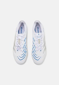 White athletic shoes with blue and silver accents, featuring curved striping patterns and a mesh tongue, designed for performance.