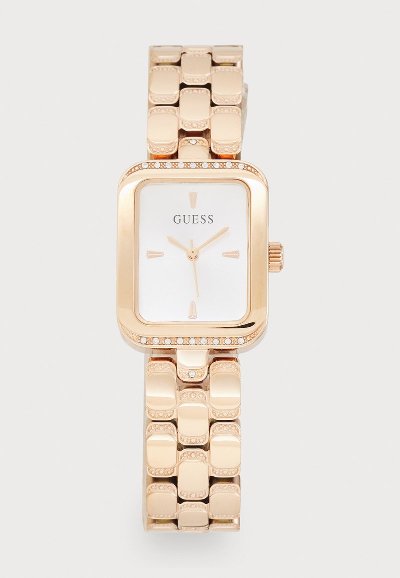 Rose gold rectangular watch with a metallic band, gem accents on the bezel, and a white dial featuring black markers and hands.