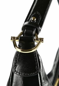 Tracolla di borsa in pelle nera con fibbia metallica color oro, caratterizzata da texture liscia e cuciture dettagliate, posizionata per una vista ravvicinata.