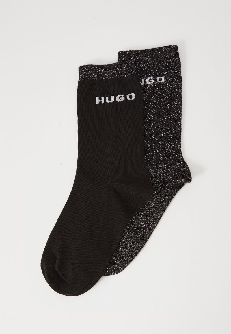 Black socks with a contrasting dark grey pair, featuring a shiny texture and "HUGO" logo in white on the cuff of each sock.