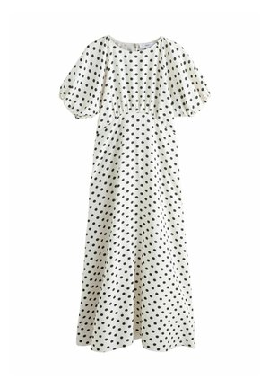 Robe longue blanche à pois noirs, manches courtes bouffantes, taille cintrée et encolure ronde.