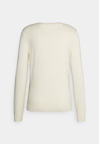 Light beige knit sweater with long sleeves, rounded neckline, and ribbed cuffs. Soft texture, minimalistic design, no visible patterns.