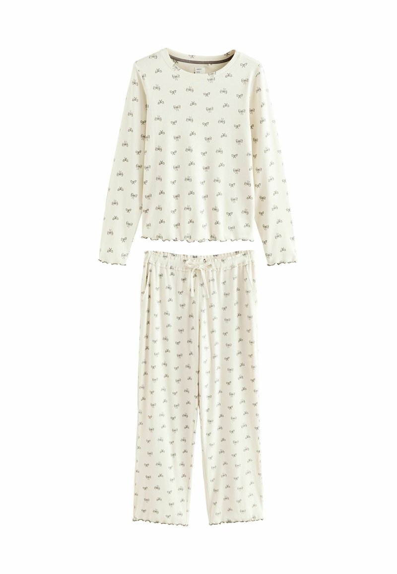 Long-sleeve, light cream pajama set with all-over small bow print; ribbed texture; elastic waistband with drawstring; scalloped edges.