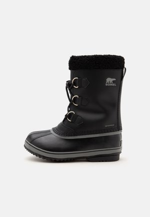 Botte d’hiver noire imperméable avec fermeture à lacets à l’avant, col en polaire, semelle en caoutchouc et logo Sorel sur le côté.