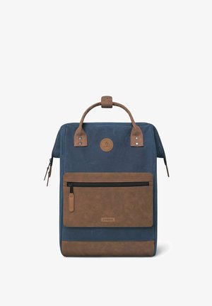 Backpack made of dark blue fabric with brown leather accents, featuring a front zipper pocket and top handle for carrying.