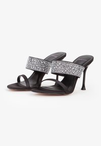 Black high-heeled sandals feature a wide, embellished strap with a bead pattern, open toe, and thin ankle strap for secure fit.