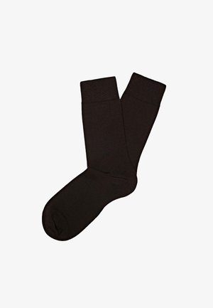 Calzini neri in cotone con polsino a coste, punta senza cuciture e texture liscia. Presentano un design al ginocchio e un colore uniforme.