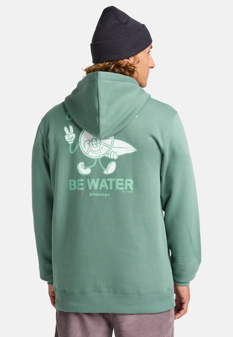 Felpa verde menta con un grande design grafico bianco sulla schiena, che presenta testo giocoso e un personaggio. Tessuto caldo e cappuccio regolabile.