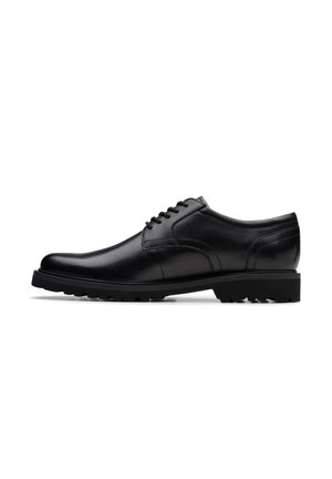 Black polished leather men's lace-up dress shoe with low heel and textured sole shown from side view.