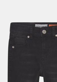 Zwarte denim jeans met een gladde textuur, vijf-pocket ontwerp, sluiting met metalen knoop en contrasterende stiksels.