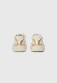 Weiße Sneakers mit goldenen Akzenten, die über eine glatte Textur, einen gepolsterten Kragen und eine dicke Sohle für zusätzlichen Komfort und Stabilität verfügen.