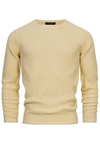 Pull en tricot jaune avec une texture, manches longues et col rond. Présente des poignets côtelés et une coupe légèrement ajustée.