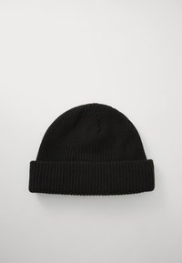 Black knitted beanie with a ribbed texture, features a rolled cuff, and a rounded top. The material appears soft and flexible.