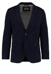 Granatowa marynarka uszyta z lekkiego materiału, z pojedynczym guzikiem, dwoma przednimi kieszeniami oraz wzorzystą podszewką. Minimalistyczny design z delikatnymi akcentami.