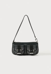 Borsa strutturata nera con design perforato, caratterizzata da due tasche frontali con fibbie, accessori in metallo argentato e una tracolla rimovibile.