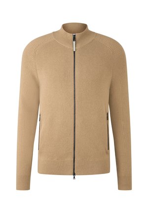 Beige sweater met ritssluiting, gemaakt van geribd stof, voorzien van een opstaande kraag en zijzakken met ritssluiting. Eenvoudig recht model.