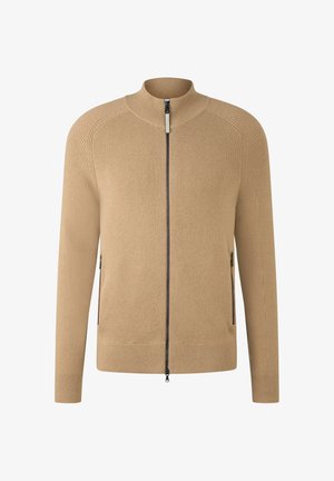 Beżowy sweter rozpinany na zamek, wykonany z prążkowanej tkaniny, z wysokim kołnierzem i bocznymi kieszeniami na zamek. Prosty, o prostym kroju.